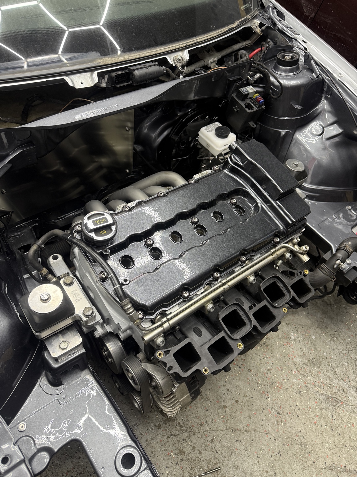 Close-up of the smoothed and painted engine bay with the engine installed